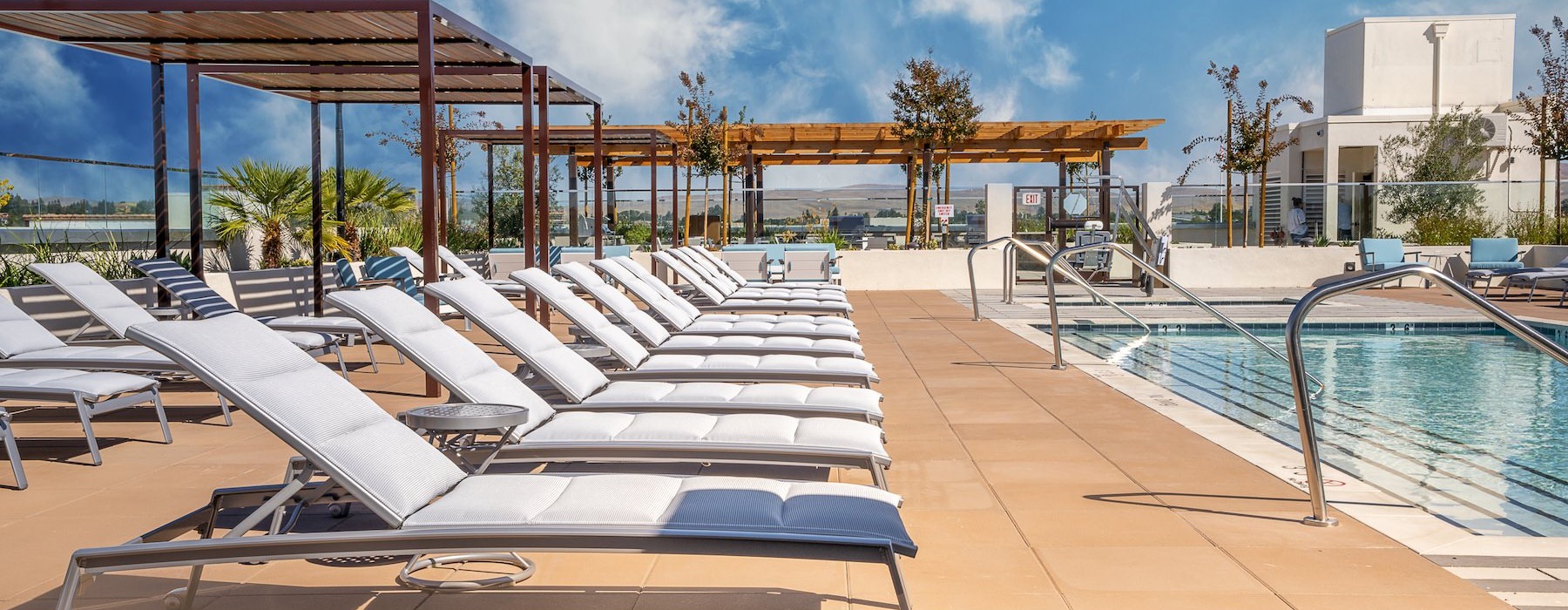 a pool with lounge chairs around it