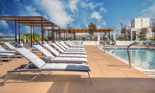 a pool with lounge chairs