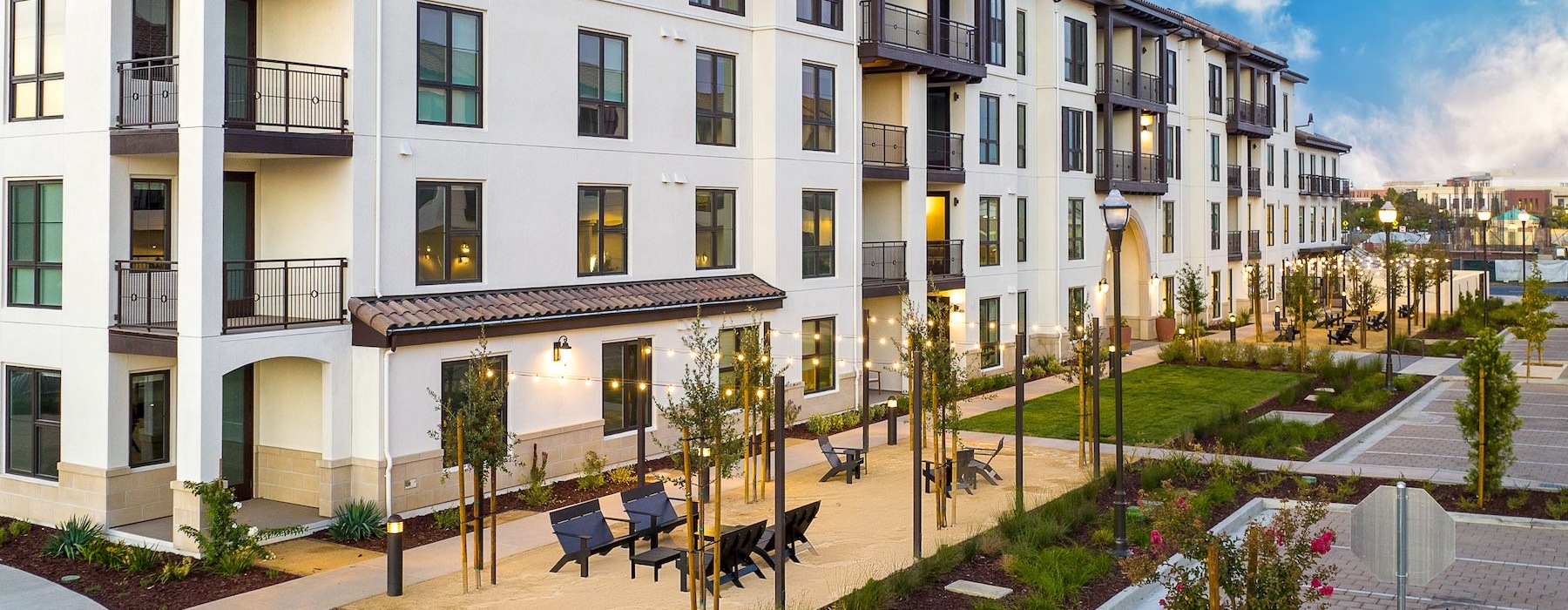a courtyard with a fountain and buildings