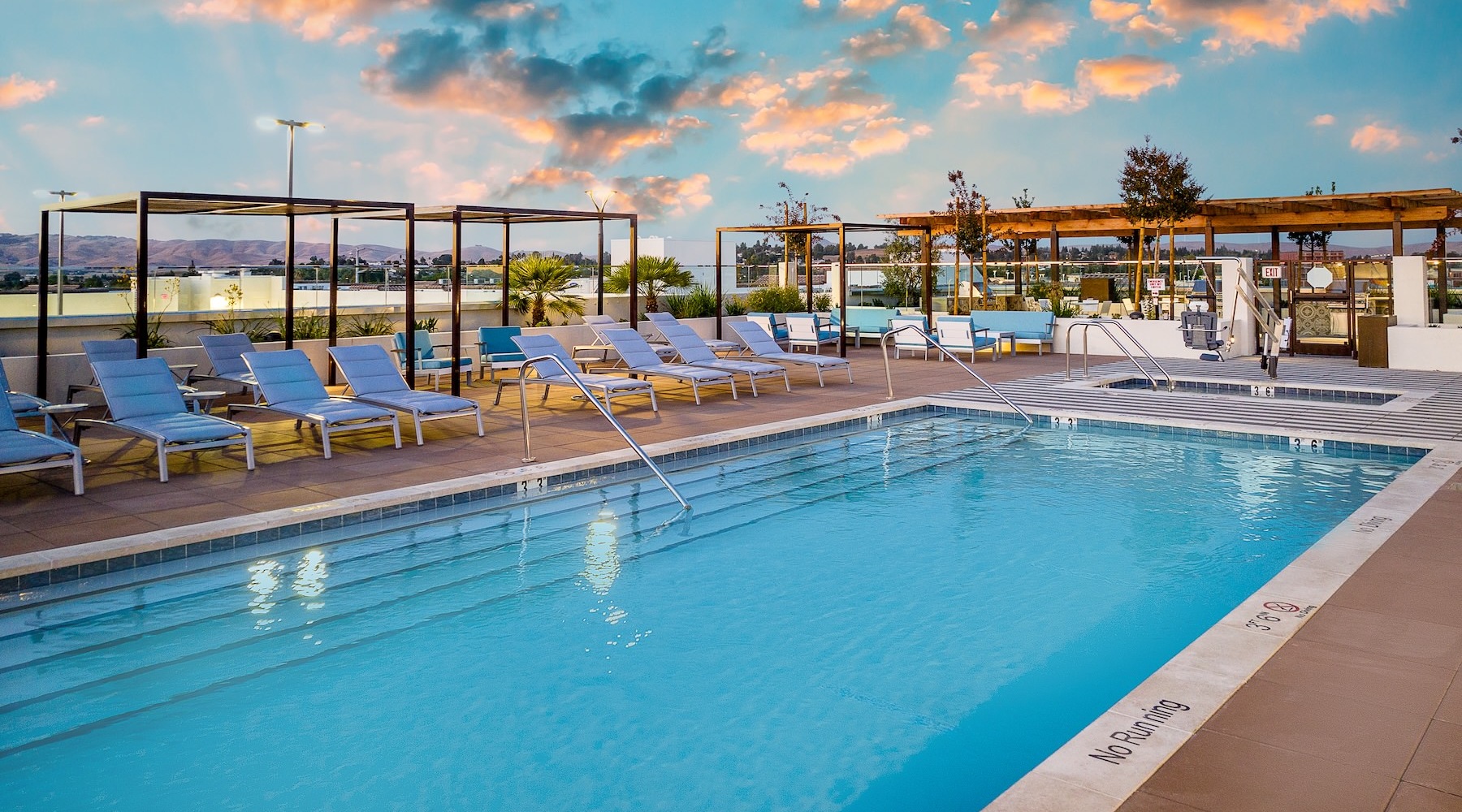 Resort-style swimming pool a swimming pool with lounge chairs