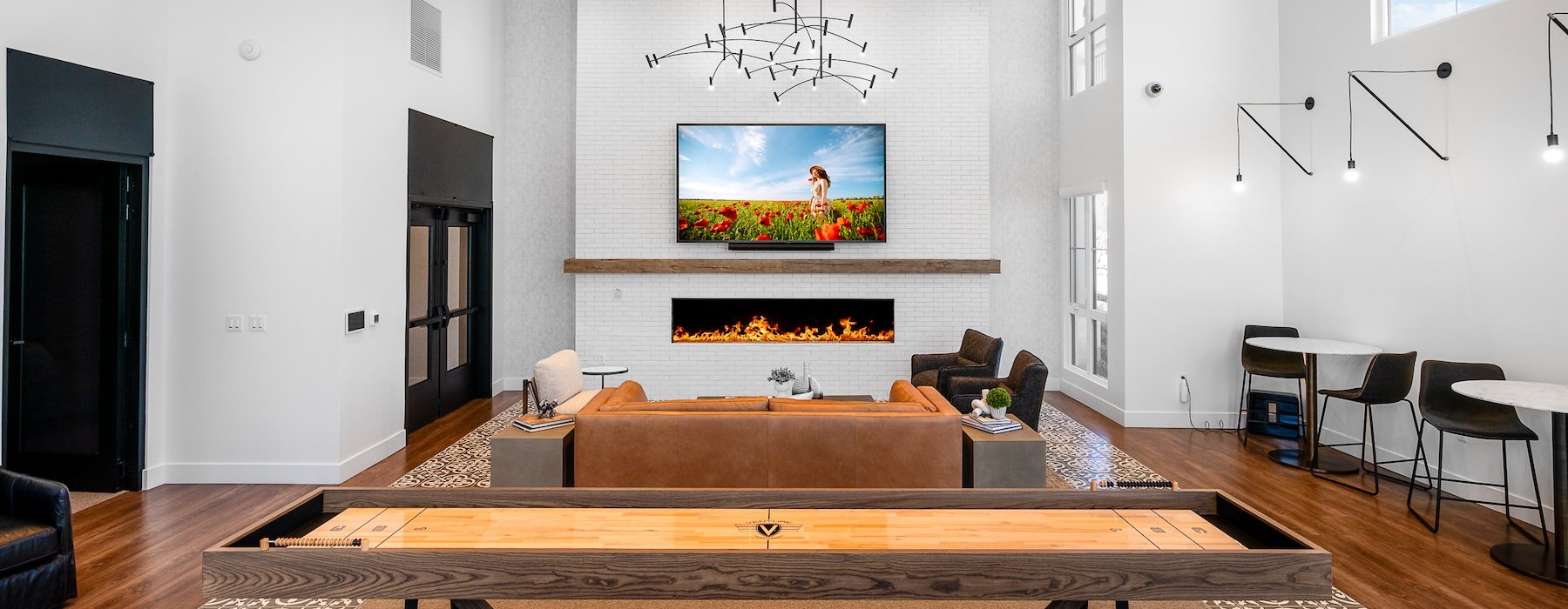 Access to resident-only features a clubroom with a tv, couch, tables and chairs