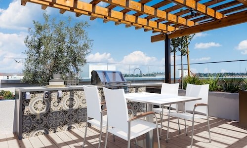 a grill area with a table and chairs