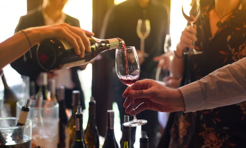 a group of people wine tasting