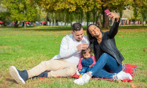 a family taking a picture in a park
