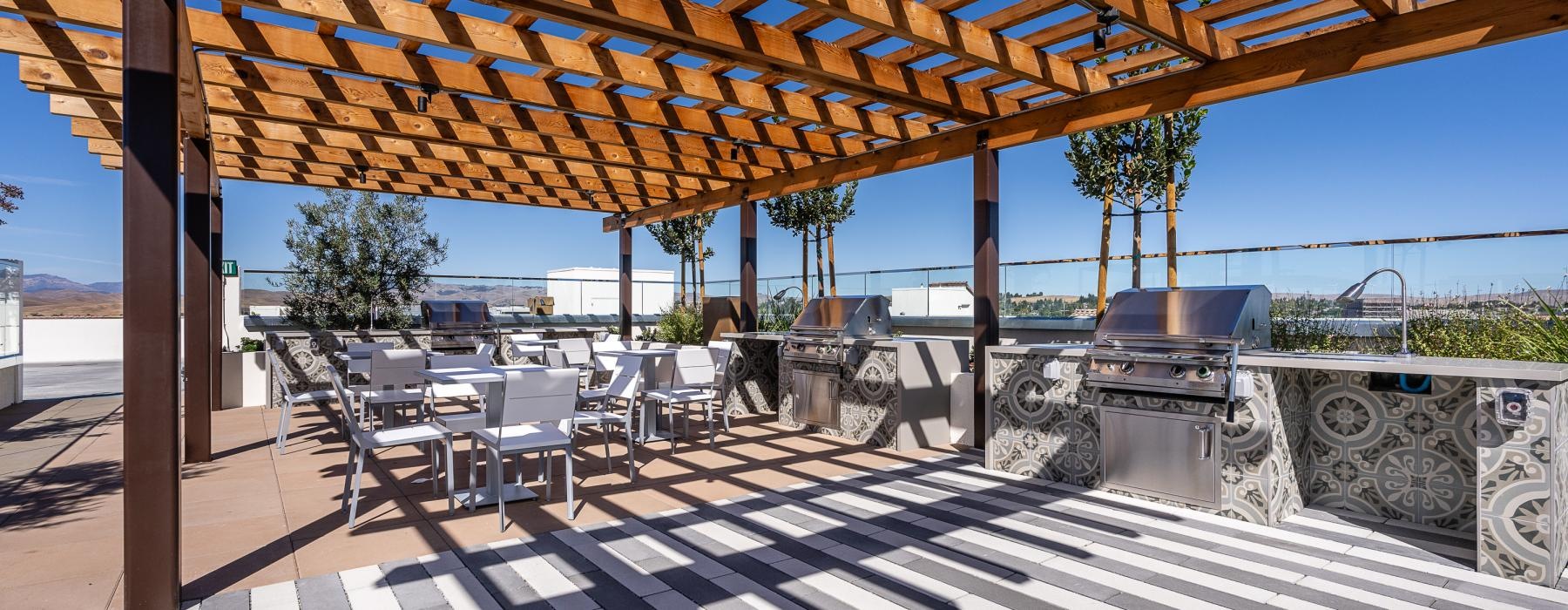 a grill area with tables and chairs