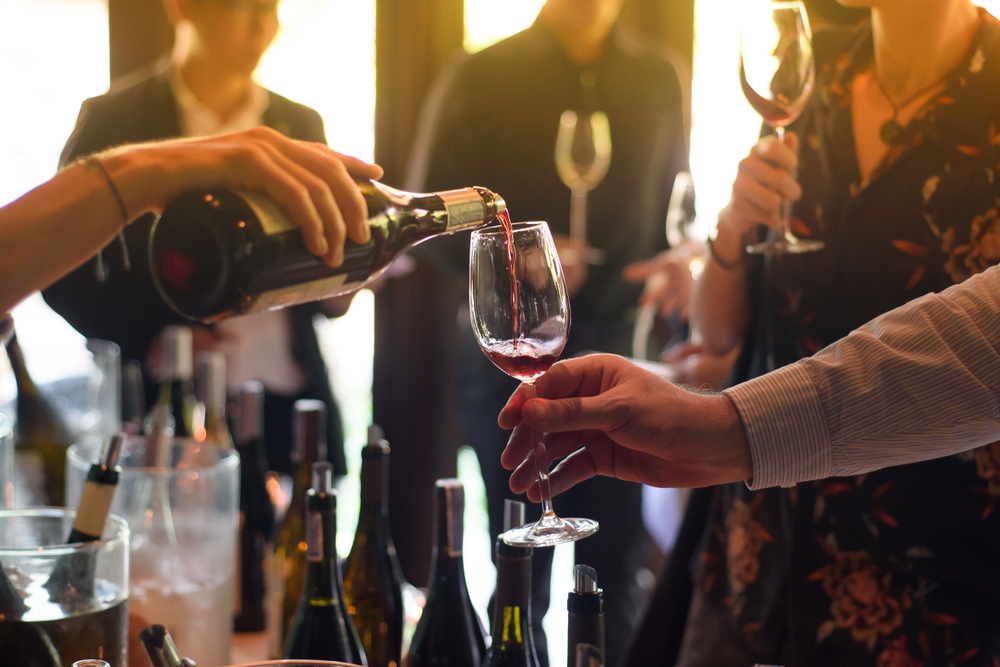 waitress pouring a glass of wine