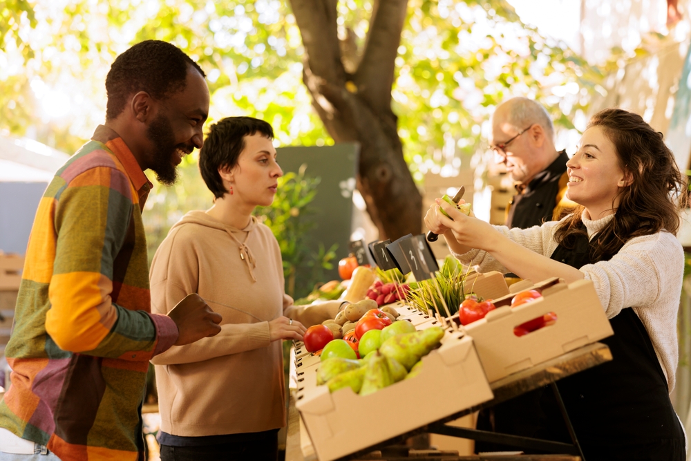 man and woman purchasing produce from a farmers market